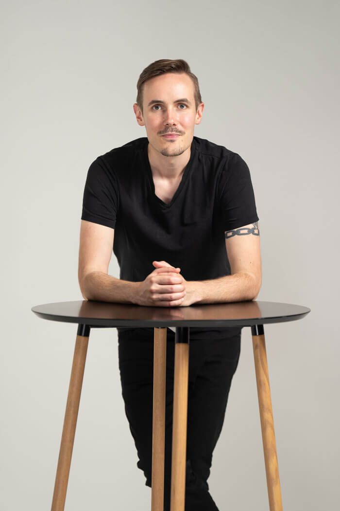 Kasper Kylmälä - puhuva insinööri, nojaamassa hymyillen pöytään.